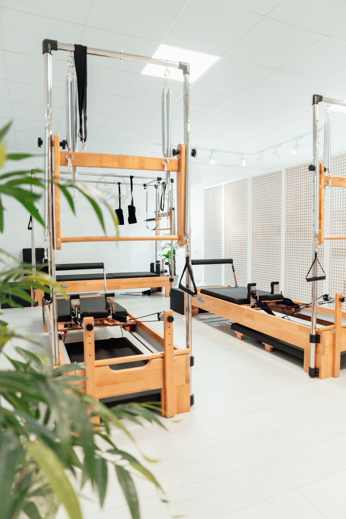 Reformers and Pilates apparatus in a bright, airy studio